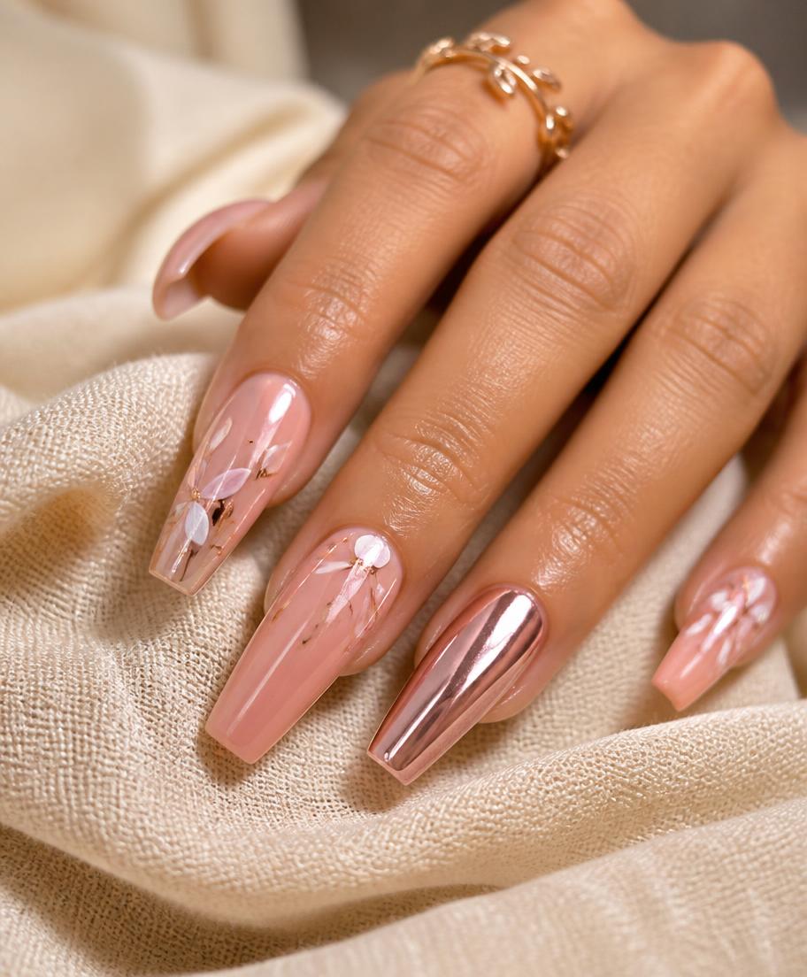 Custom acrylic nail art in blush pink and rose gold chrome